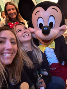 teammates at Disneyland meeting Mickey Mouse