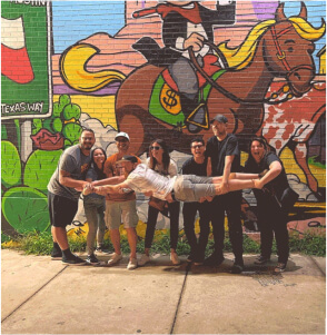team pic antics in front of mural in Austin Texas